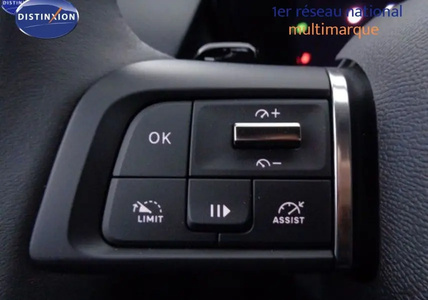 Gros plan sur les commandes au volant noir du Citroën C5 X 2022, avec boutons de régulateur de vitesse et assistance.