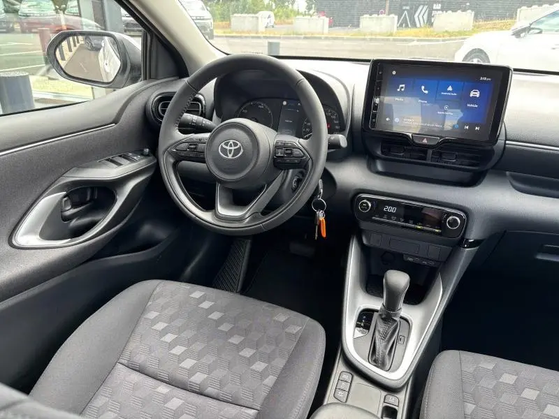 Intérieur de la Toyota Yaris 116h Dynamic 5p MC24 vu côté conducteur, volant multifonction et écran tactile visibles.