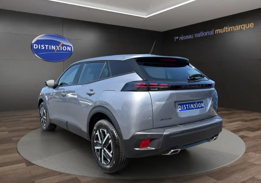 Peugeot 2008 Hybrid 145 e-DCS6 STYLE gris clair, vue 3/4 arrière droit, feux LED et jantes alliage visibles.