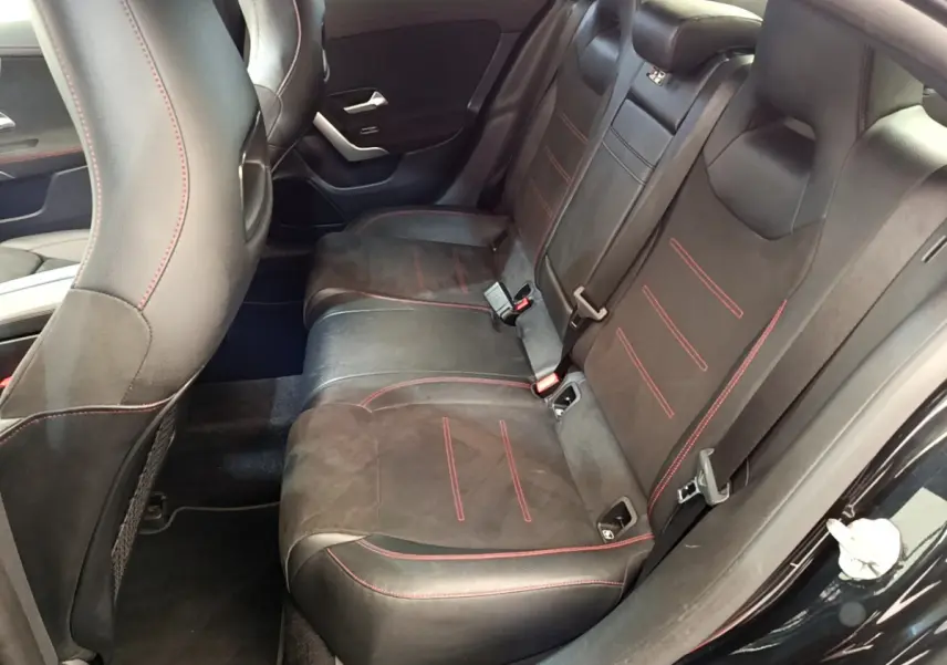 Vue intérieure côté droit des sièges arrière noirs avec surpiqûres rouges de la Mercedes CLA 200 d AMG Line 2021