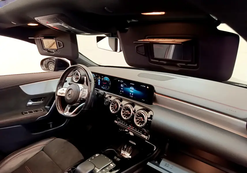 Intérieur noir de la Mercedes CLA 200 d AMG Line 2021 vu côté conducteur, tableau de bord digital et volant cuir.