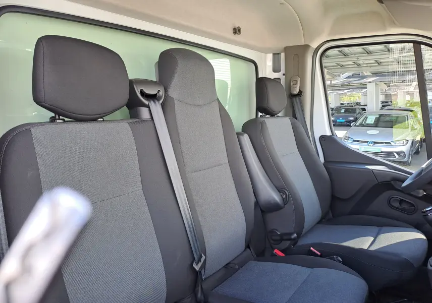 Vue intérieure côté droit du Nissan Interstar Châssis Cabine 2024, montrant les sièges tissu gris et noir avec ceinture de sécurité.
