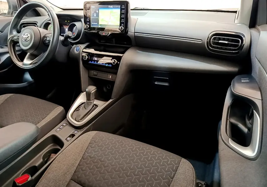 Intérieur de la Toyota Yaris Cross 2022 vu côté passager, avec tableau de bord noir et écran tactile central.