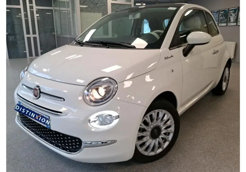 Vue 3/4 avant droite d'une Fiat 500 blanche Bossa Nova, avec phares allumés et jantes multibranches distinctives.