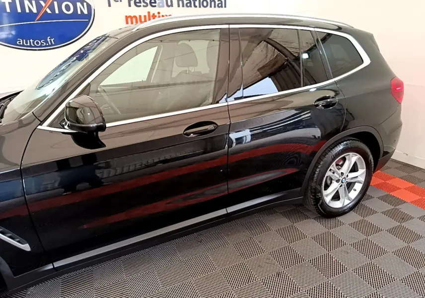 Vue latérale côté gauche d'un BMW X3 noir 2020 avec jantes alliage et rétroviseurs noirs brillants.