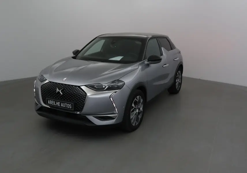 DS3 Crossback E-TENSE gris Artense vu en 3/4 avant droit, avec calandre distinctive et feux LED verticaux.