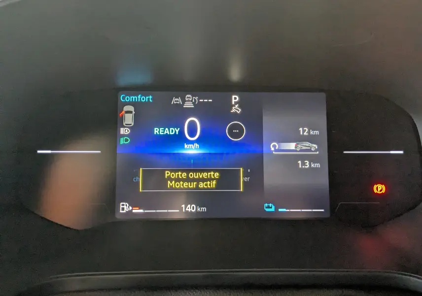 Tableau de bord numérique du Renault Captur E-Tech gris cassiopée, affichant vitesse zéro et alerte porte ouverte.