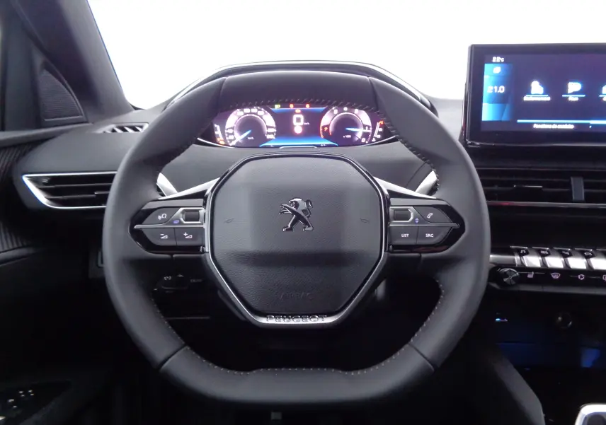 Volant noir au design compact du Peugeot 5008 2023 avec tableau de bord numérique et écran tactile central visible.
