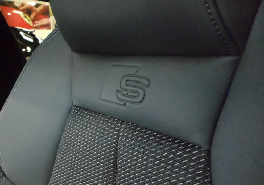 Gros plan sur le siège avant en cuir noir avec logo S embossé, intérieur de l'Audi A3 Sportback 2025.