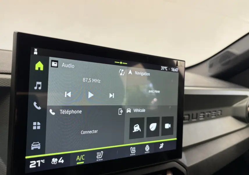 Écran tactile central affichant la navigation et audio dans l'habitacle du Dacia Duster noir 2025.