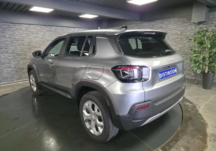 Jeep Avenger gris métallisé vu en 3/4 arrière droit, avec jantes alliage 17 pouces et feux arrière LED.