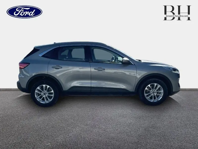 Profil côté gauche du Ford Kuga 2023 gris Solar métallisé avec jantes alu et poignées ton carrosserie visibles.