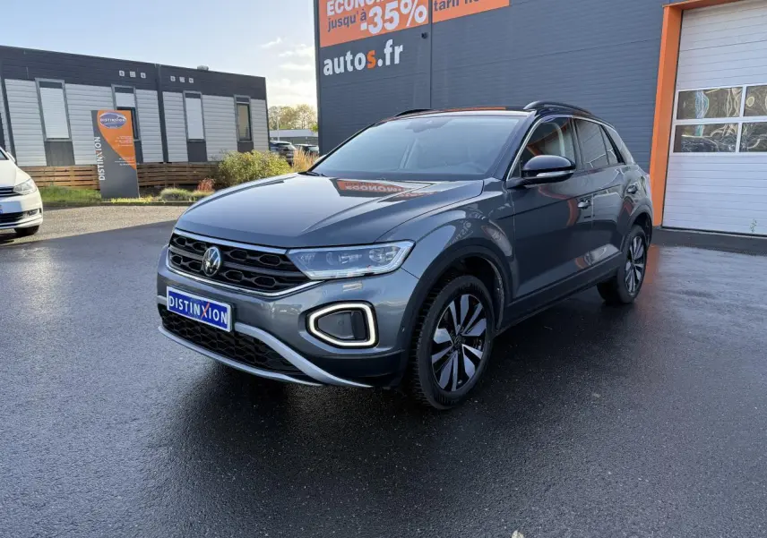 Volkswagen T-Roc gris Indium métallisé en 3/4 avant droit, avec toit noir et jantes distinctives.