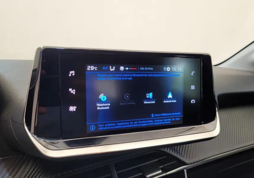 Écran tactile central de 7 pouces dans l'habitacle d'une Peugeot 208 gris foncé, affichant les options connectées Bluetooth et Apple CarPlay.