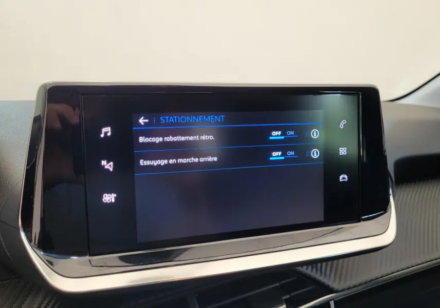 Écran tactile central de la Peugeot 208 Active Pack 2023 affichant les options de stationnement, intérieur noir.