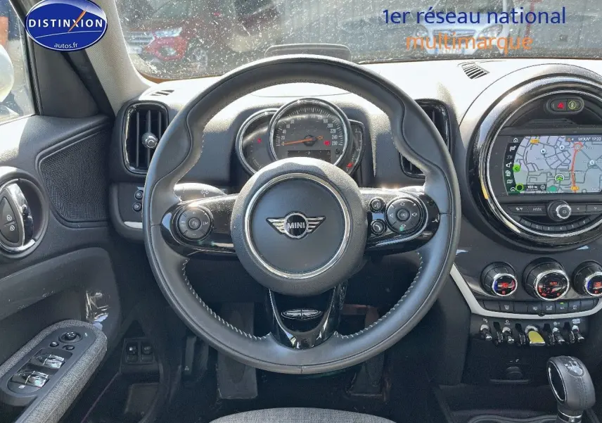 Vue intérieure centrée sur le volant cuir multifonction d'une MINI Countryman Moonwalk Grey avec écran GPS circulaire.
