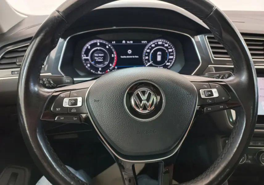 Vue rapprochée du volant cuir noir du Volkswagen Tiguan Allspace 2018 avec tableau de bord numérique allumé.