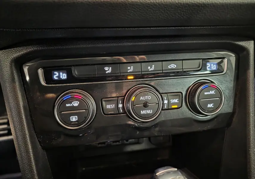 Gros plan sur la console centrale du Volkswagen Tiguan 2019 montrant les commandes de climatisation automatique tri-zone.