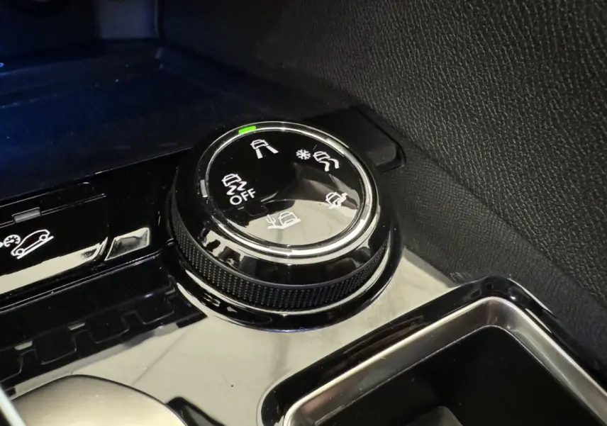 Gros plan sur la molette de sélection des modes de conduite dans l'habitacle du Peugeot 3008 blanc.