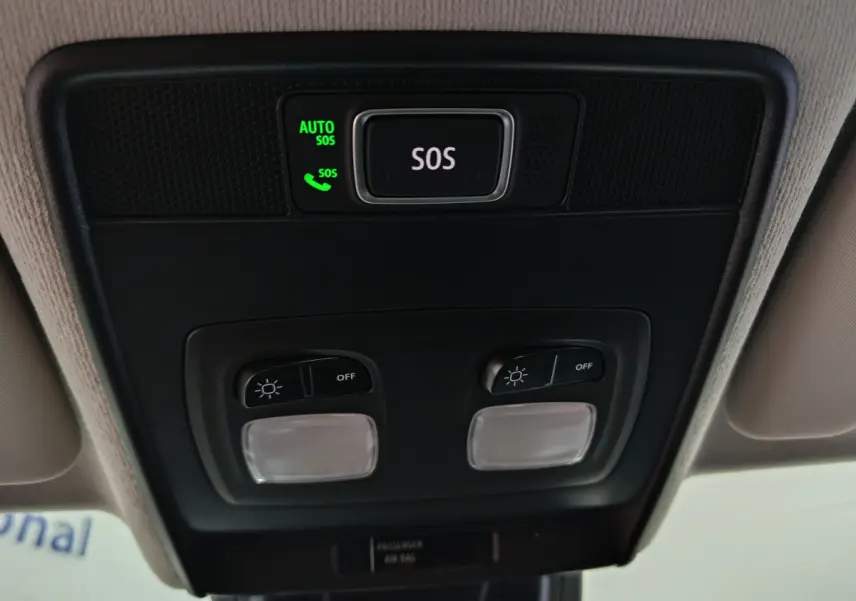 Vue en gros plan du plafonnier intérieur de la Renault Clio gris foncé, avec bouton SOS et commandes d'éclairage.