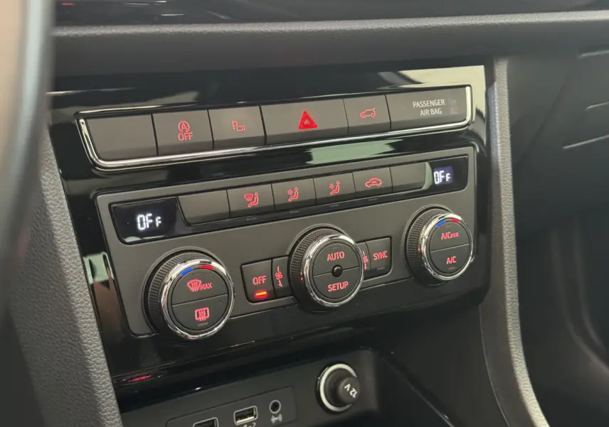 Gros plan sur la console centrale noire du SEAT Ateca 2019, montrant les commandes de climatisation et prises USB.