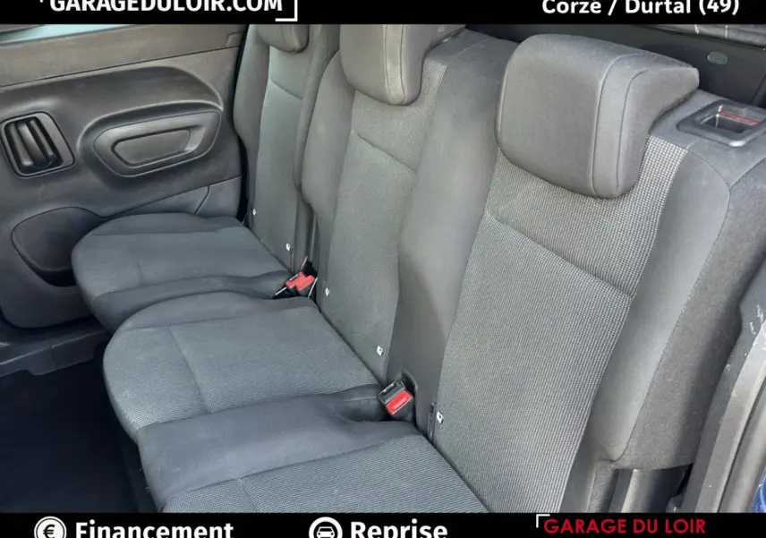 Vue intérieure des sièges arrière gris foncé du Peugeot Rifter 2024, version Allure, avec ceintures de sécurité visibles.