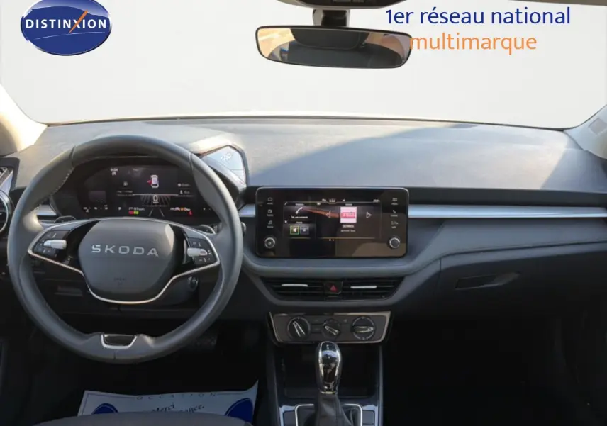 Vue intérieure frontale du tableau de bord et volant noir de la Skoda Fabia 2025 avec écran tactile central et boîte automatique.