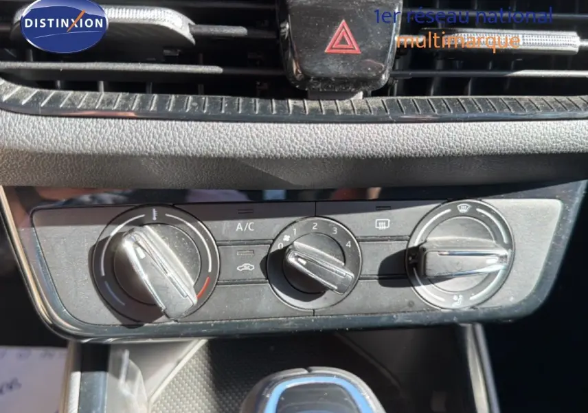 Gros plan sur les commandes de climatisation et la console centrale d’une Skoda Fabia blanche Glacier, version 2025.
