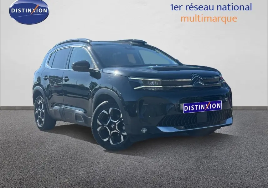 Citroën C5 Aircross noir Perla Nera vue 3/4 avant droit avec jantes alu et barres de toit visibles.