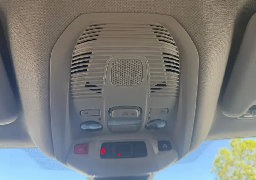 Vue intérieure en contre-plongée du plafonnier gris clair avec commandes et bouton SOS du Citroën C5 Aircross 2025.