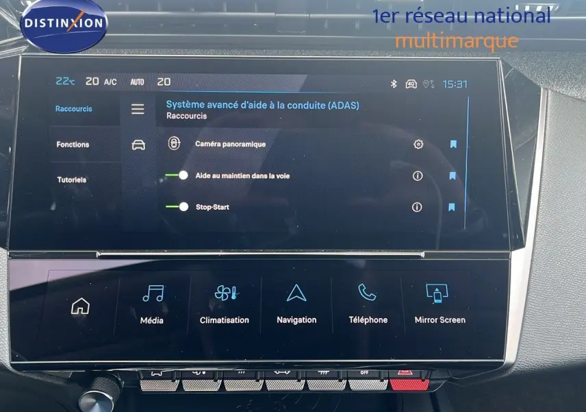 Écran tactile central du tableau de bord de la Peugeot 308 hybride 2024 affichant les aides à la conduite et la climatisation.
