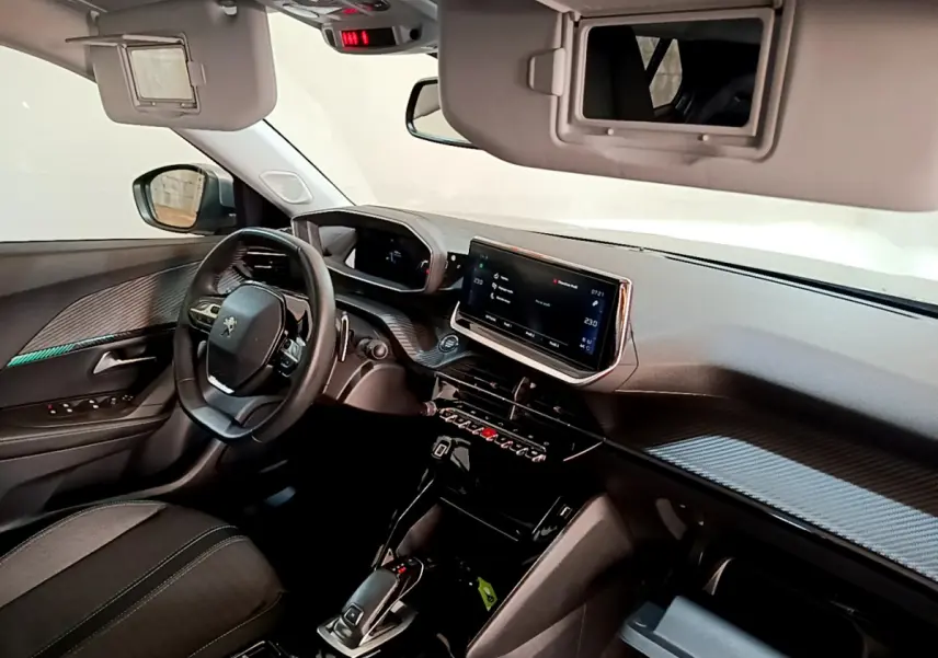 Intérieur Peugeot 2008 gris clair, vue côté conducteur sur tableau de bord et écran tactile central lumineux.