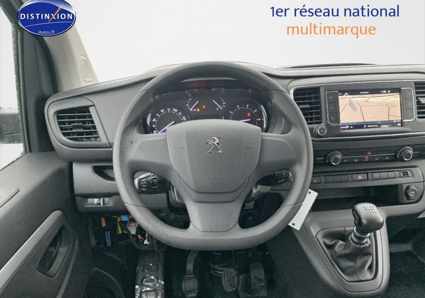 Vue intérieure centrée sur le volant Peugeot et la console avec levier de vitesse manuelle du Expert Blanc Kaolin 2023.