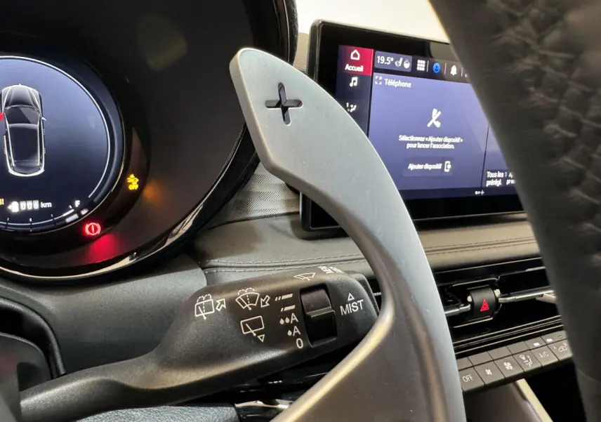 Gros plan sur la palette de changement de vitesse côté droit et l'écran tactile du tableau de bord de l'Alfa Romeo Tonale rouge.