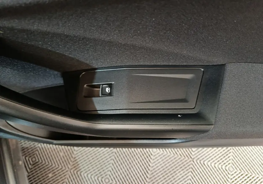 Détail de la commande de verrouillage sur la porte intérieure côté gauche du Volkswagen T-Roc gris foncé 2021.