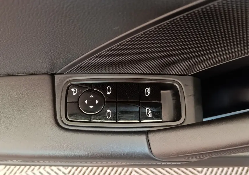 Gros plan sur les commandes de réglage des rétroviseurs et vitres côté gauche d'une Porsche 911 Carrera 4S Coupé gris foncé de 2019.