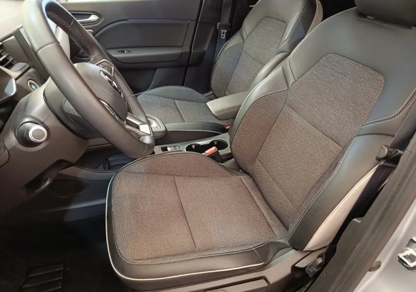 Vue intérieure côté conducteur du Renault Captur Intens E-TECH 2021, sièges tissu gris et cuir noir, volant multifonctions.
