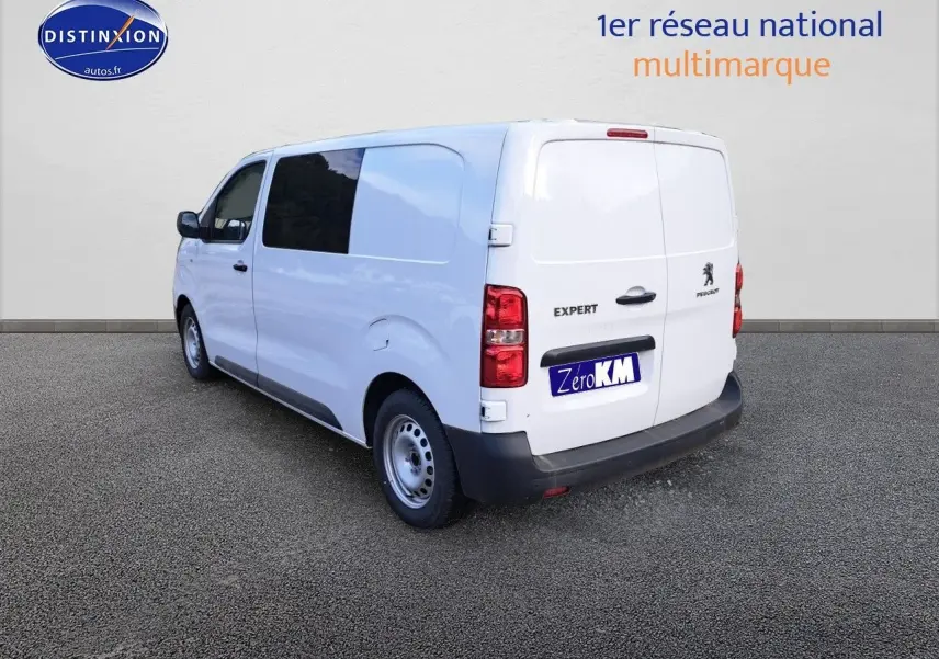 Vue 3/4 arrière droite d'un Peugeot Expert blanc Kaolin, fourgon utilitaire avec vitres arrière teintées.