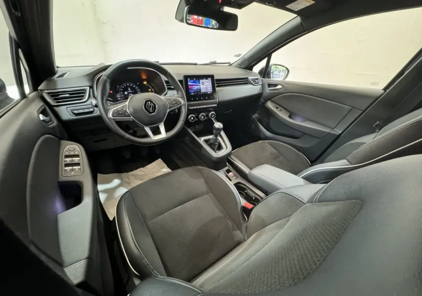 Intérieur Renault Clio Intens TCe 100 2020 vu côté conducteur, tableau de bord avec écran tactile et volant cuir noir.