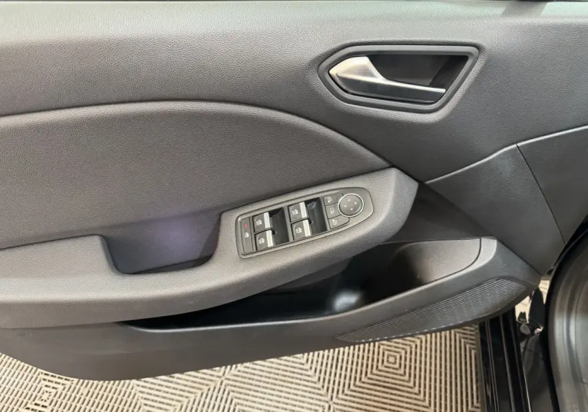 Vue rapprochée de la porte avant gauche noire de la Renault Clio Intens 2020 avec commandes électriques des vitres et rétroviseurs.