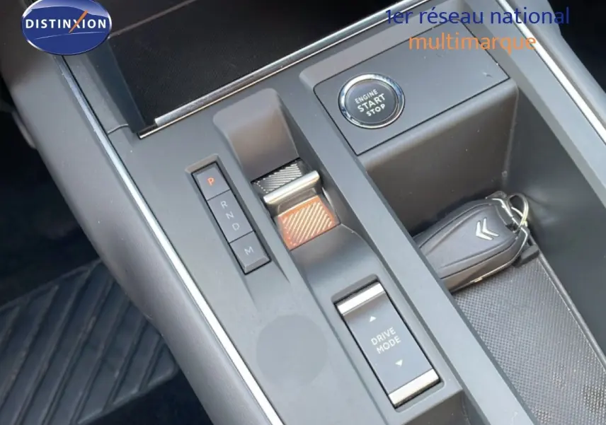 Vue plongeante sur la console centrale du Citroën C5 Aircross bleu Eclipse Metal, avec bouton start/stop et clé Citroën.