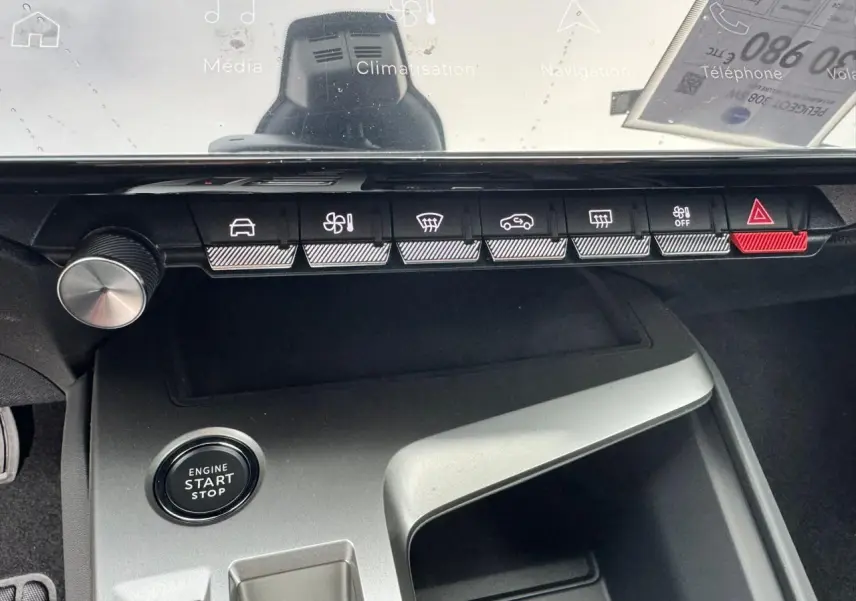 Vue rapprochée de la console centrale de la Peugeot 308 SW blanche, avec boutons de commande et bouton start/stop.