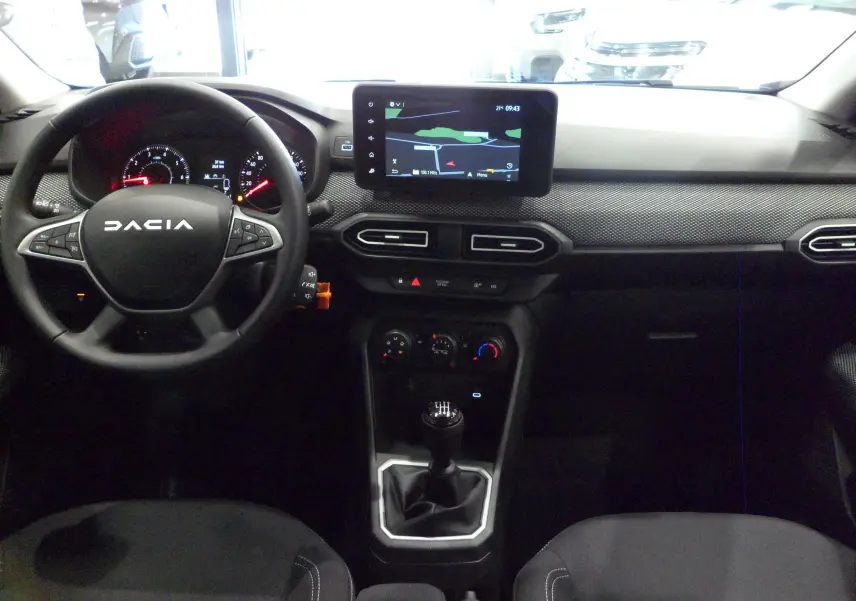 Vue intérieure du tableau de bord et volant DACIA Jogger TCe 110, avec écran tactile et levier de vitesses manuel.