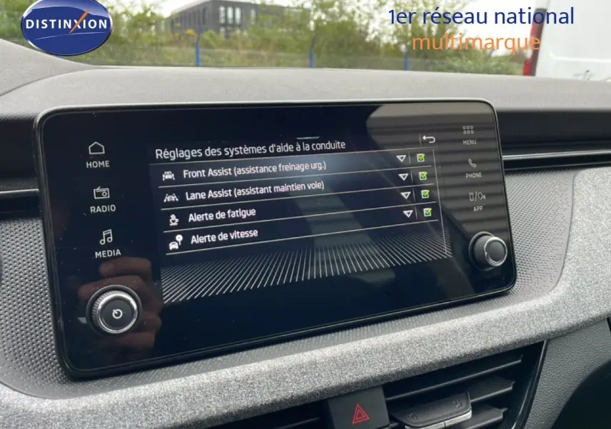Écran tactile du système d’aide à la conduite dans un Skoda Kamiq 2025, tableau de bord gris clair texturé.
