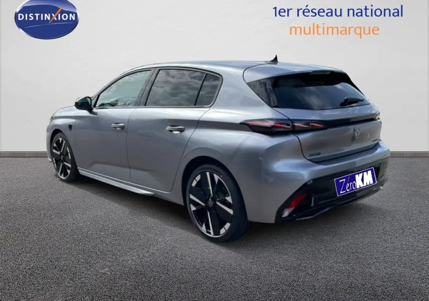 Peugeot 308 gris Artense métal vue 3/4 arrière droit, jantes noires et détails noirs contrastants.