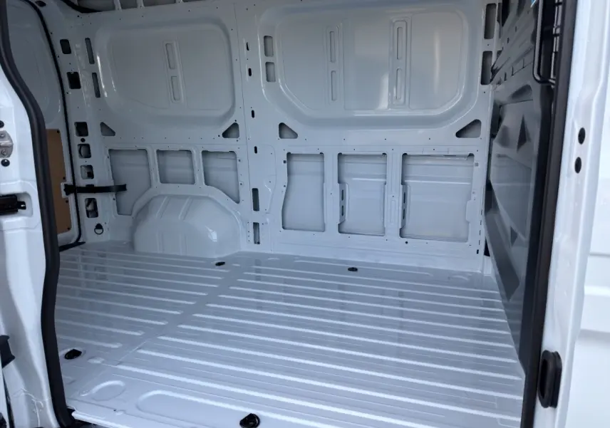 Vue intérieure arrière du Renault Master blanc montrant la zone de chargement vide et spacieuse.