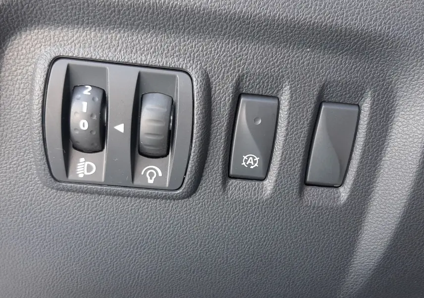 Gros plan sur la commande des vitres électriques et réglage des rétroviseurs côté conducteur d'un Renault Captur gris platine 2019.