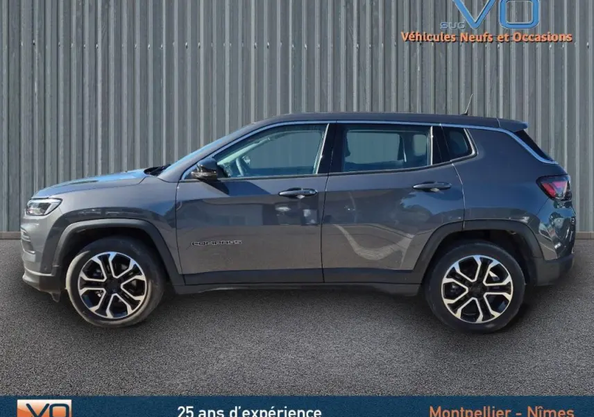 Vue latérale droite d'un Jeep Compass gris 2024 avec jantes alliage 18 pouces et rétroviseurs électriques rabattables.