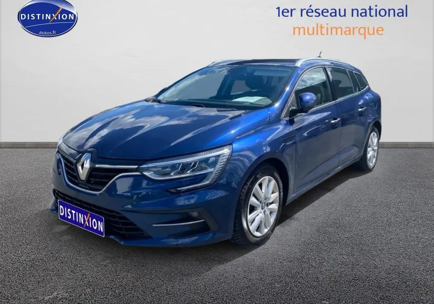 Renault Mégane IV Estate bleu en 3/4 avant droit, avec jantes alu et calandre chromée visible.