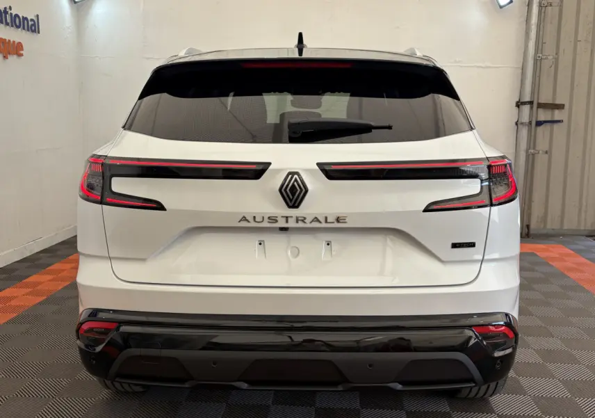 Vue arrière d'un Renault Austral blanc avec feux LED horizontaux et logo central bien visible.